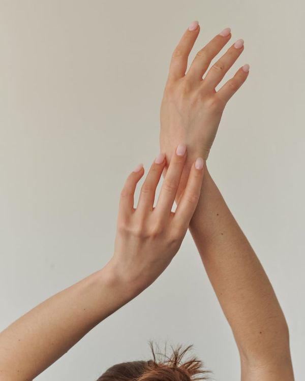 Woman performing a gentle neck stretch in a calm environment.